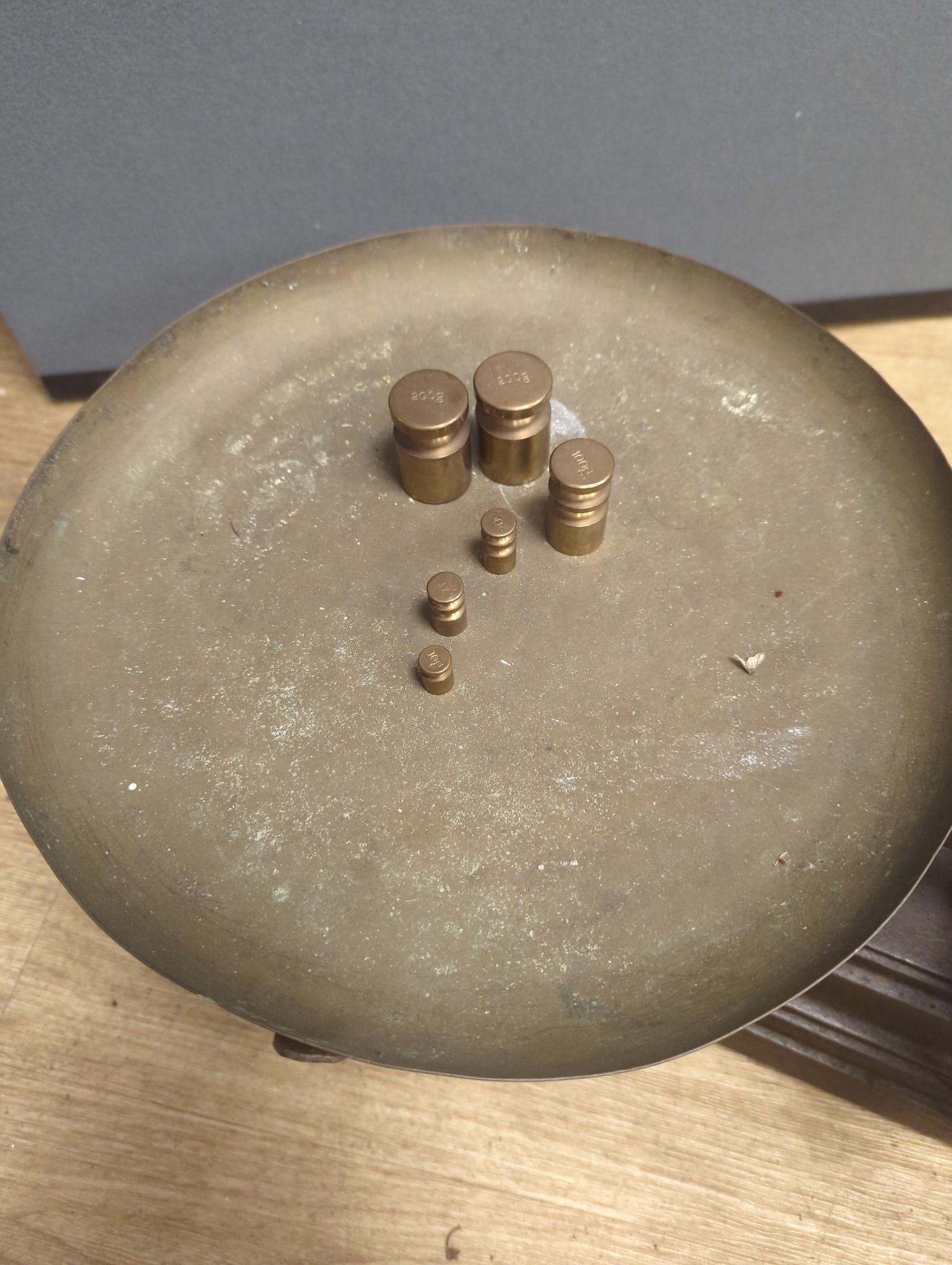 A large French cast iron and brass weighing scale, 82 cms wide.